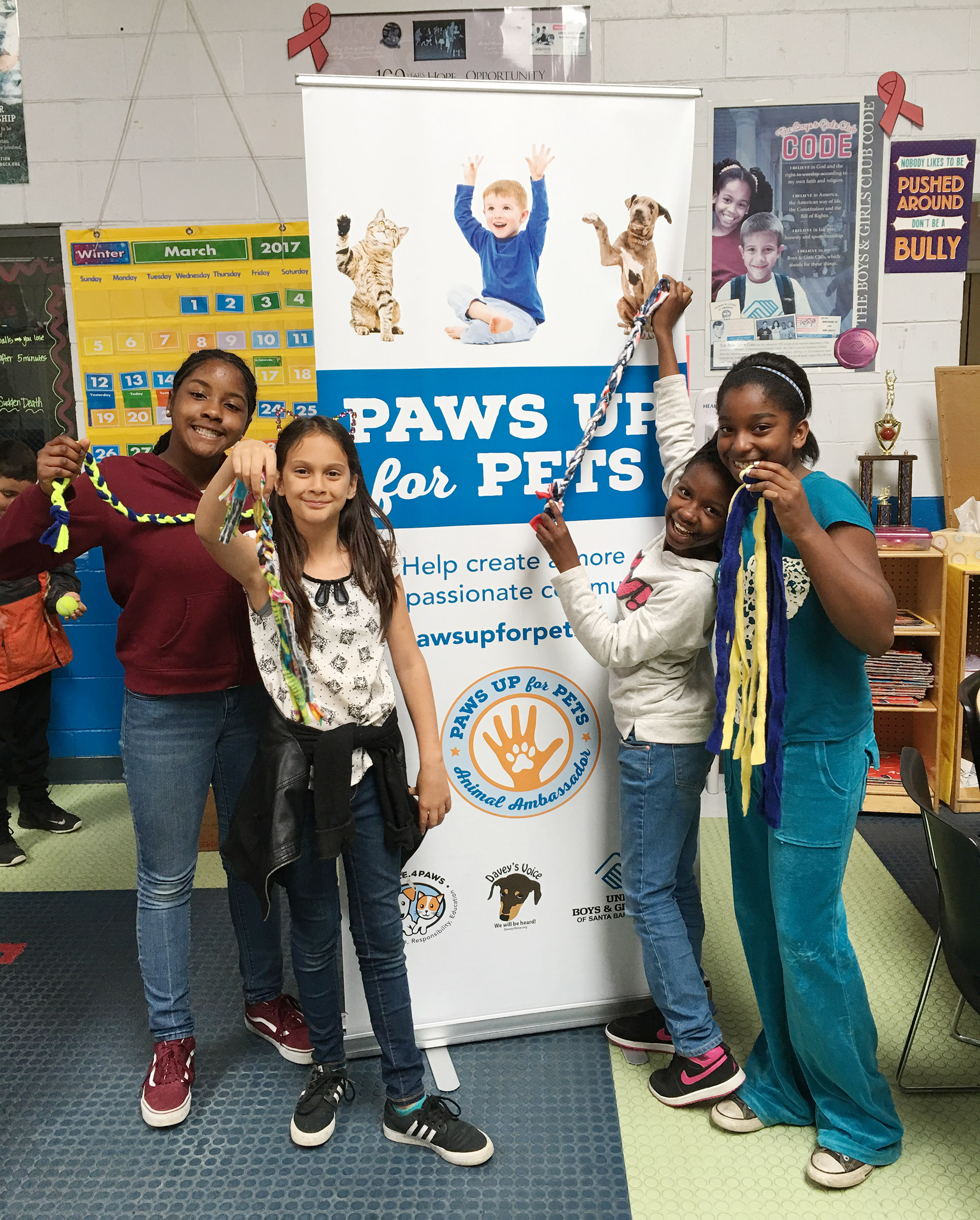 Youth at Paws Up For Pets showing compassion for small stuffed animal